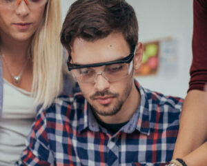 Group of students working on a computer part