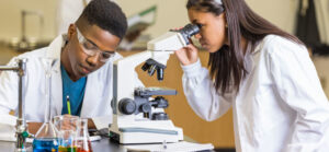Two students using microscope