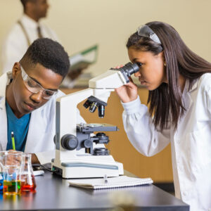 Two students using microscope